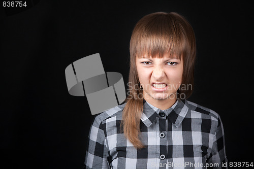 Image of Young beautiful girl snarls