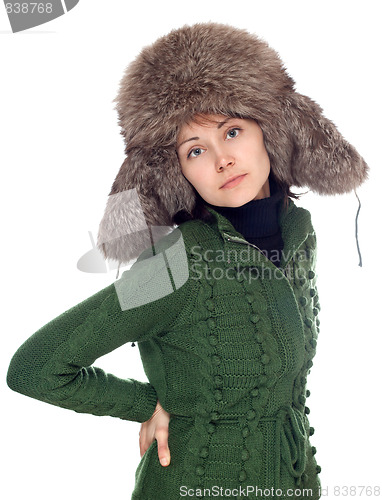 Image of Beautiful girl in green sweater and fur hat