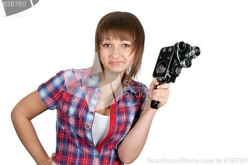 Image of Beautiful girl in plaid shirt with movie camera