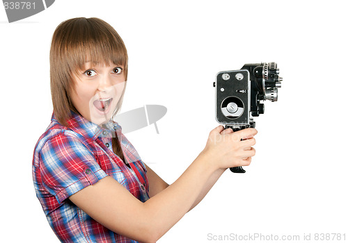 Image of Beautiful girl in plaid shirt with movie camera