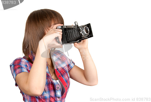 Image of Young girl with old analog photo by camera