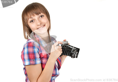 Image of Young girl with old analog photo by camera