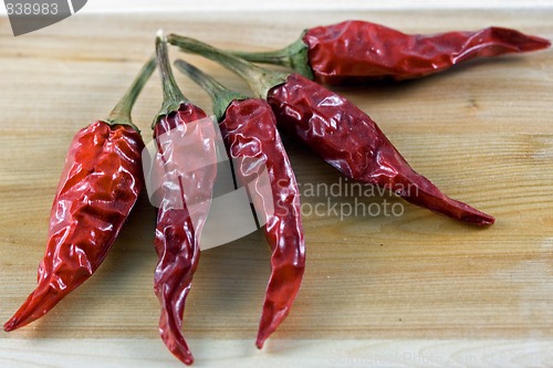 Image of Red chillie on juniper wood chopping board