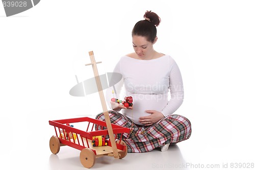 Image of pregnant woman and toys 