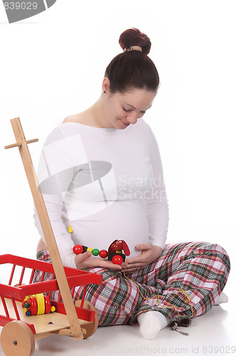 Image of pregnant woman and toys 