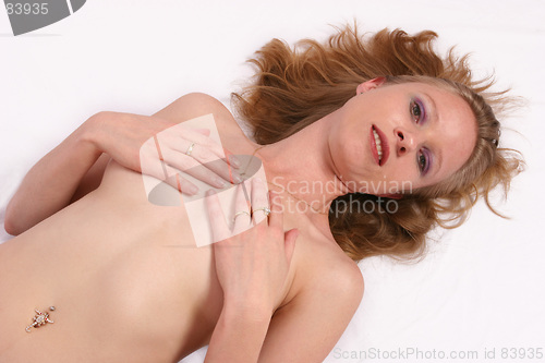 Image of Naked woman laying on ground