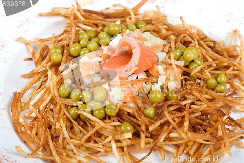 Image of Russian salad with salmon fish closeup