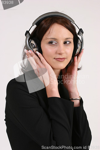 Image of Businesswoman listening to her favorite music