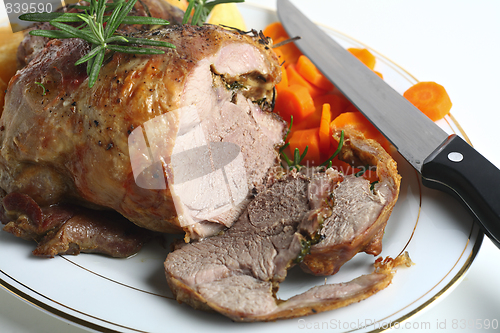 Image of Joint of lamb with carving knife