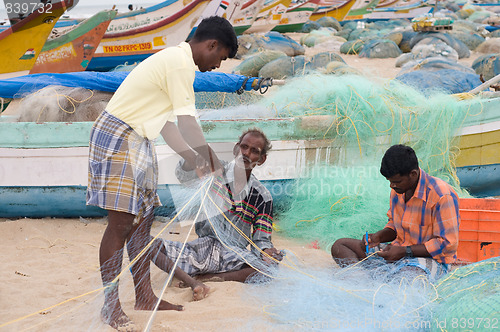 Image of Fisherman weaving nets in the Indian coastline