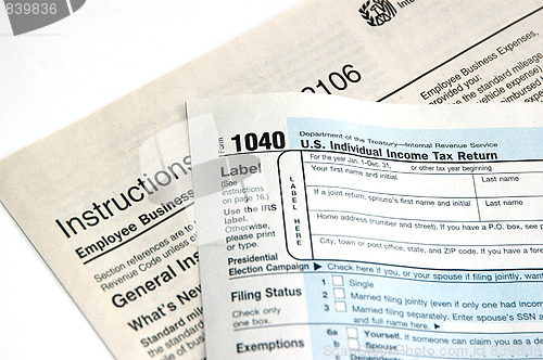 Image of Hand signing a tax form concept of filing tax