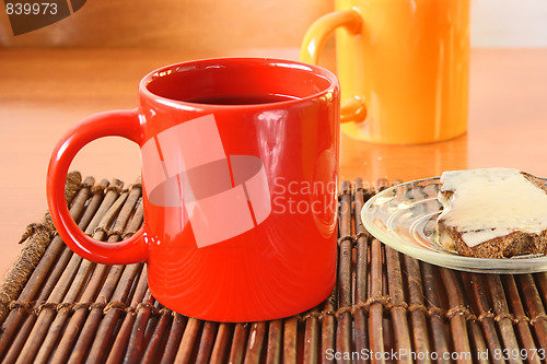 Image of Red mug and chips on glass plate