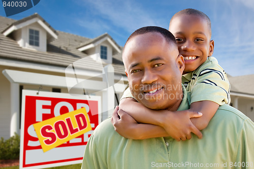 Image of Father with Son In Front of Real Estate Sign and Home