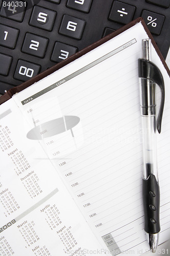 Image of Calculator, Pen and Notebook