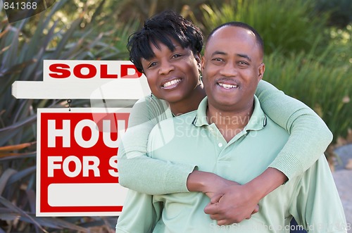 Image of Happy Couple and Real Estate Sign