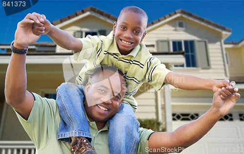 Image of Playful Father and Son In Front of Home