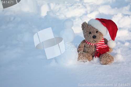Image of Bear making a snowman.