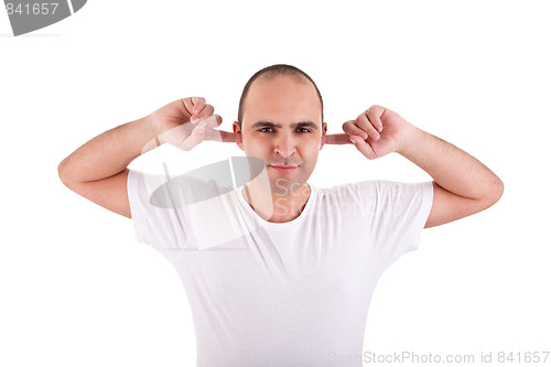 Image of Young man, holding fingers in his ears, protecting himself from noise