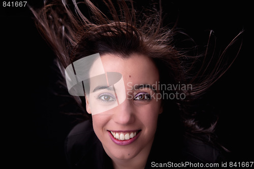 Image of young woman from the front, with her hair in the wind