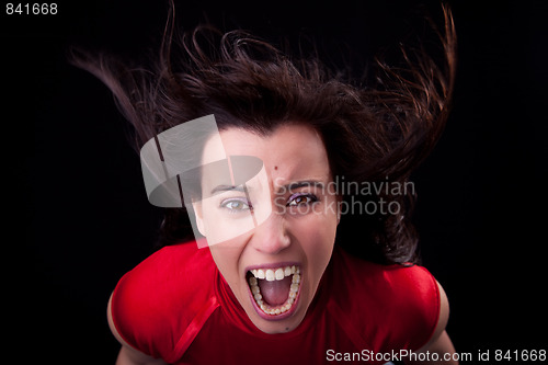 Image of beautiful young woman with her hair in the wind, screaming in fury