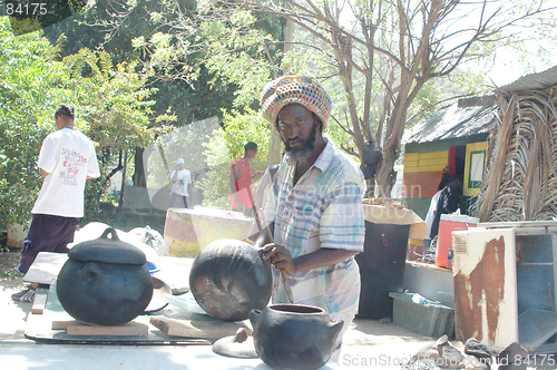 Image of rasta man preparing food 320