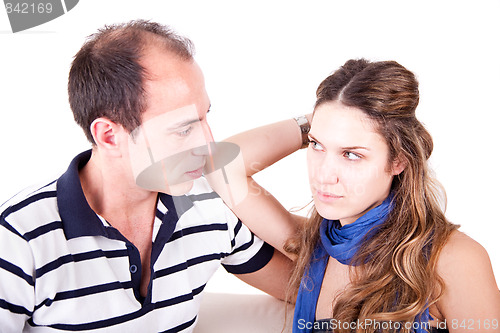 Image of a couple looking for another, sitting on the couch