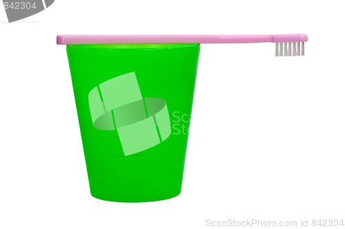 Image of Pink toothbrush and green cup for children