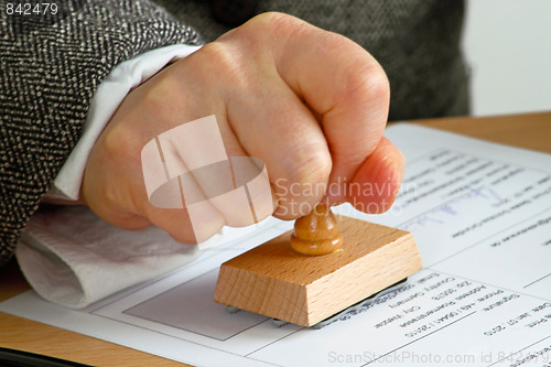 Image of Stamping  a document