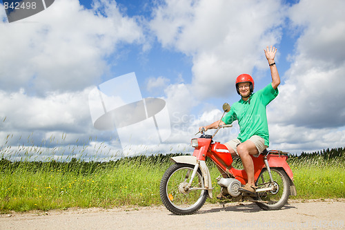 Image of Happy man driving a moped