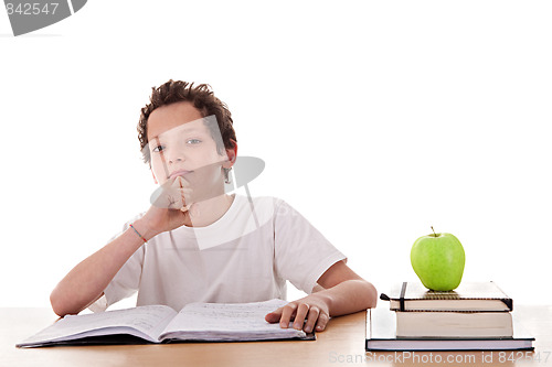 Image of boy studying and thinking, along with one on apple top of some books