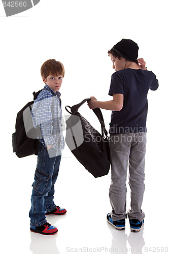 Image of two students seen with his back to the school bags, one looking back