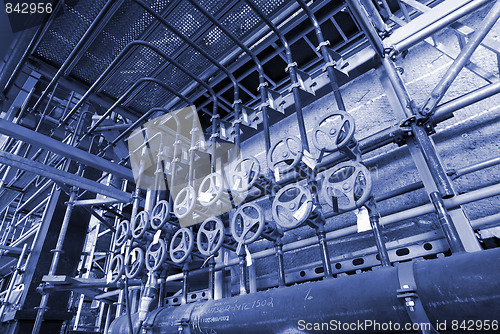 Image of Pipes, tubes, machinery and steam turbine at a power plant