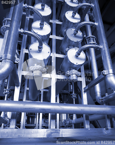 Image of Pipes, tubes, machinery and steam turbine at a power plant