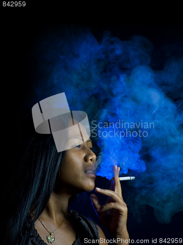 Image of beautiful woman smoking a cigarette