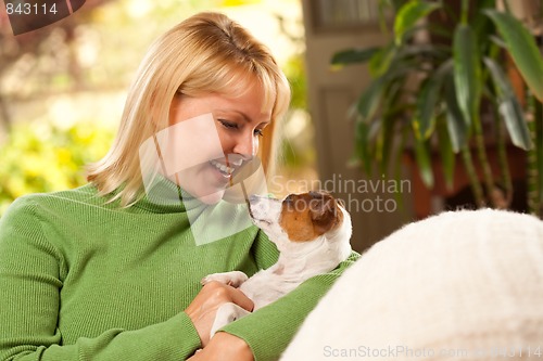 Image of Woman and Puppy Enjoying Their Day on The Sofa