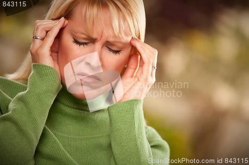 Image of Grimacing Woman Suffering a Headache