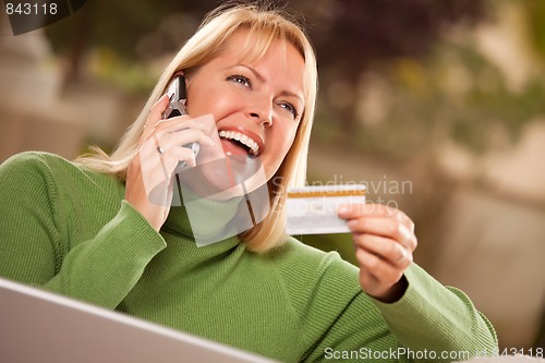 Image of Cheerful Woman on Phone and Laptop with Credit Card