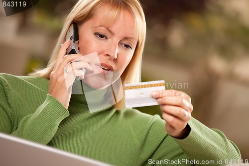 Image of Cheerful Woman on Phone and Laptop with Credit Card