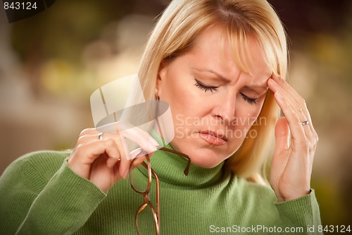 Image of Grimacing Woman Suffering a Headache