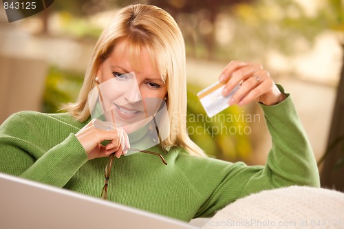 Image of Beautiful Woman with Credit Card Using Laptop