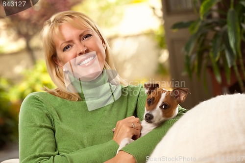 Image of Woman and Puppy Enjoying Their Day on The Sofa