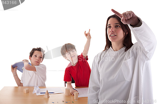 Image of two students in the classroom, to make ugly gestures the teacher
