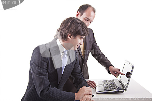 Image of Two businessmen working together on a laptop