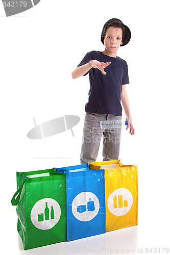 Image of boy putting a plastic bottle to recycle