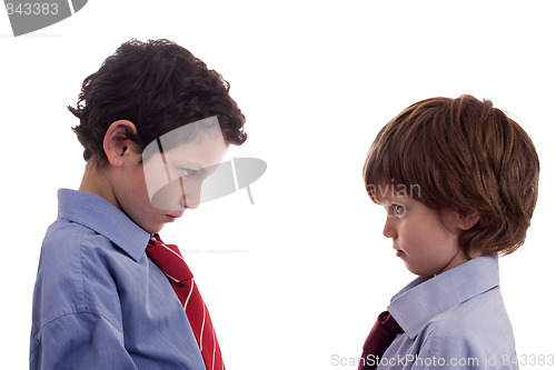 Image of two little businessmen confronted, face to face