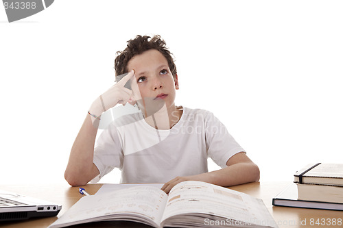 Image of cute boy on the desk studying and thinking