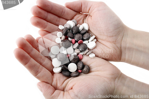 Image of Hands with variety of pills