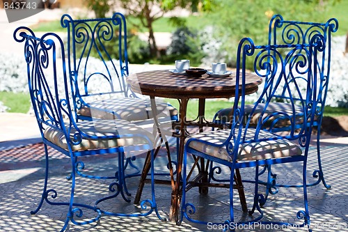 Image of Table with chairs in the garden