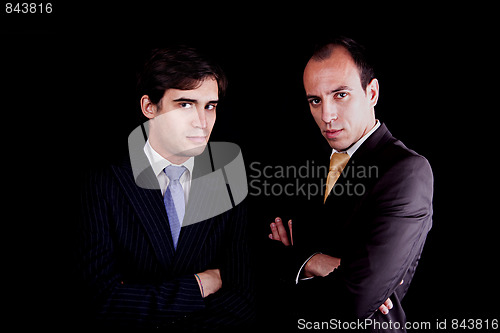 Image of two young businessmen with a serious look