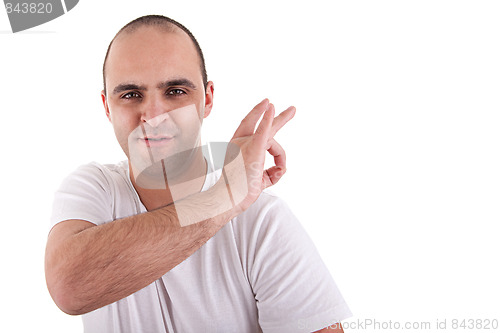 Image of young man with a finger to remove something that is on the shoulder